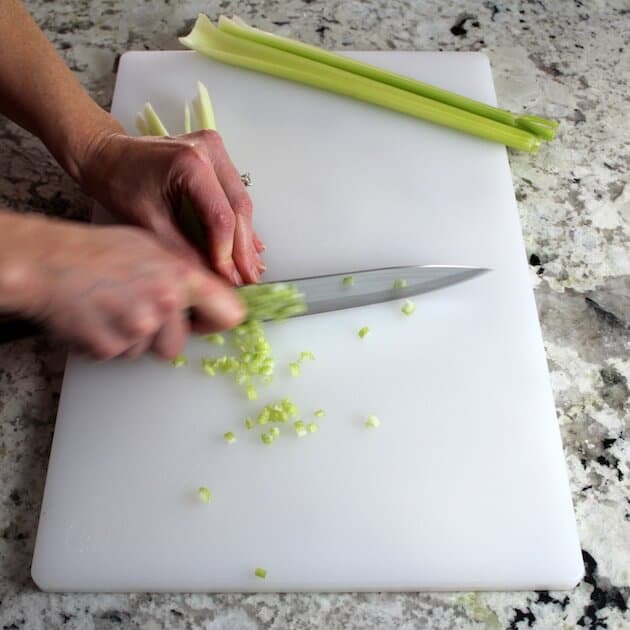 Dicing celery on a cutting board