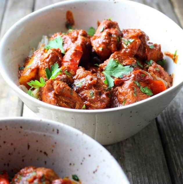 Lemon Harissa Chicken in serving bowl on farm table 