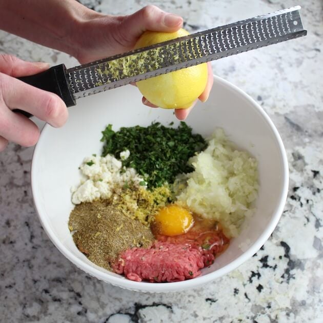 Zesting lemon into bowl of ingredients 