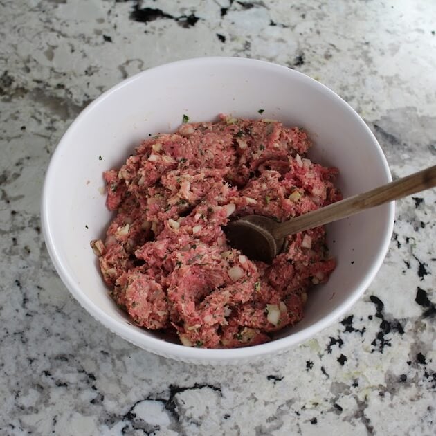 Meatball ingredients combined in mixing bowl