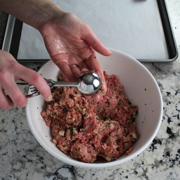 Scooping them out of the mixing bowl with a 11/2 in scoop.