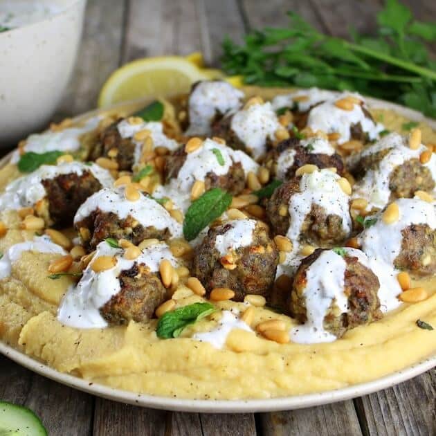 Lamb meatballs on plate of yellow pea puree