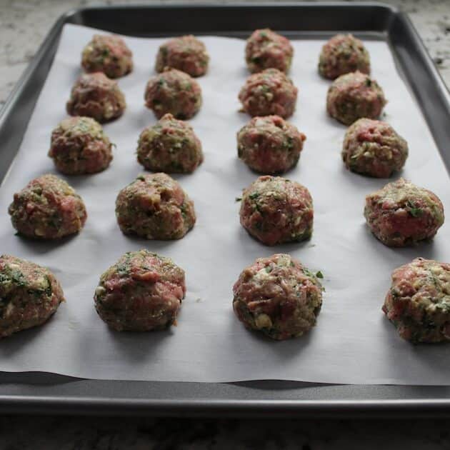 Lamb Meatballs lined up on a baking sheet before cooking