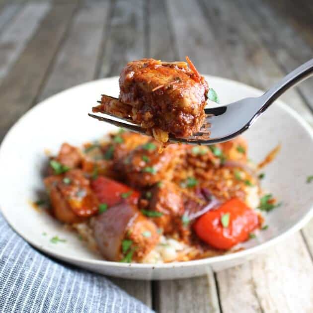 Fork holding a piece of Lemon Harissa Chicken