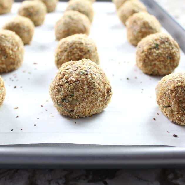 Eye level Vegetarian Meatballs on parchment paper ready to cook