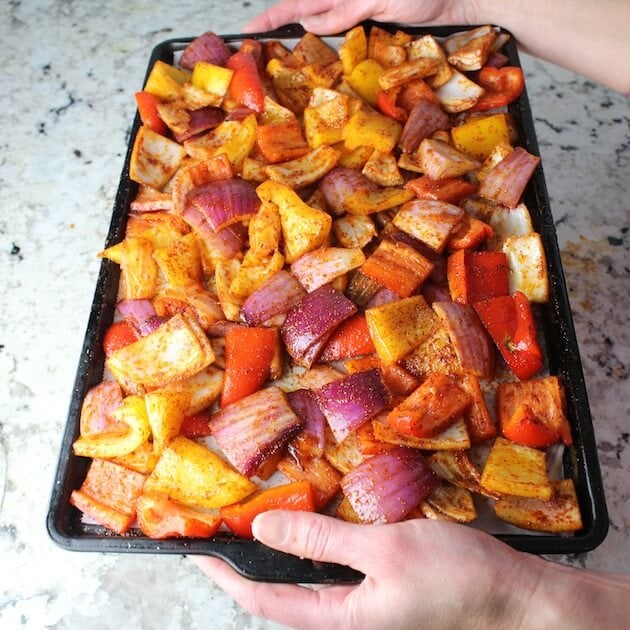 Seasoned veggies on a baking sheet.