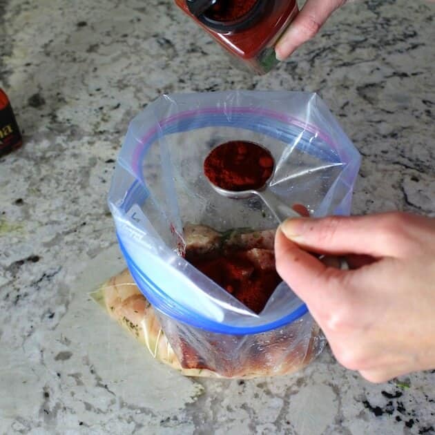 Adding spices to the marinade.