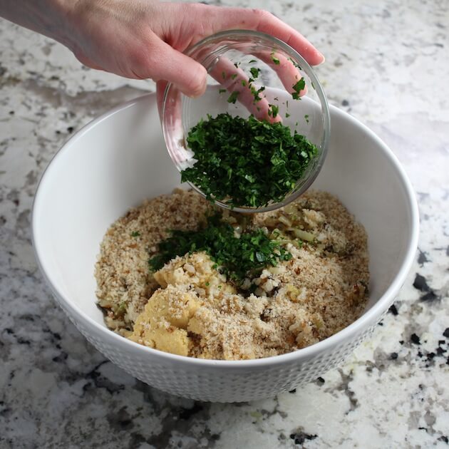 Adding parsley to mixing bowl