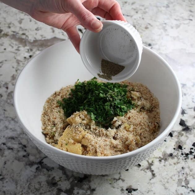 Adding pepper to mixing bowl