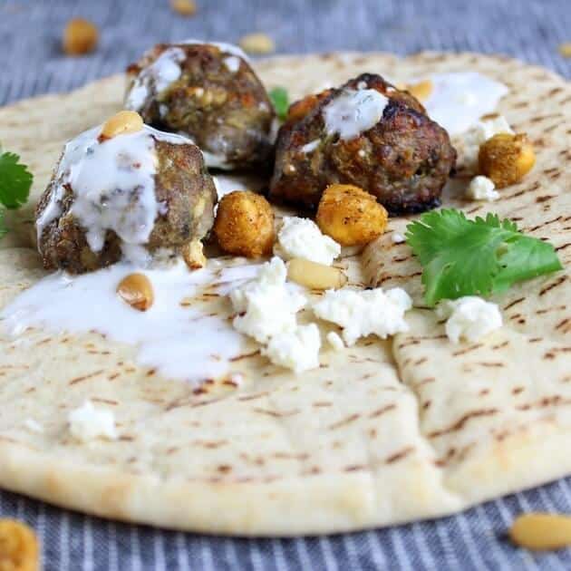 Three Lamb Meatballs on a pita with feta and roasted chickpeas