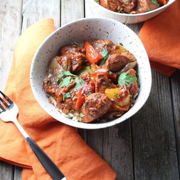 A bowl of a north African-inspired Chicken Harissa recipe with Peppers and Onions.