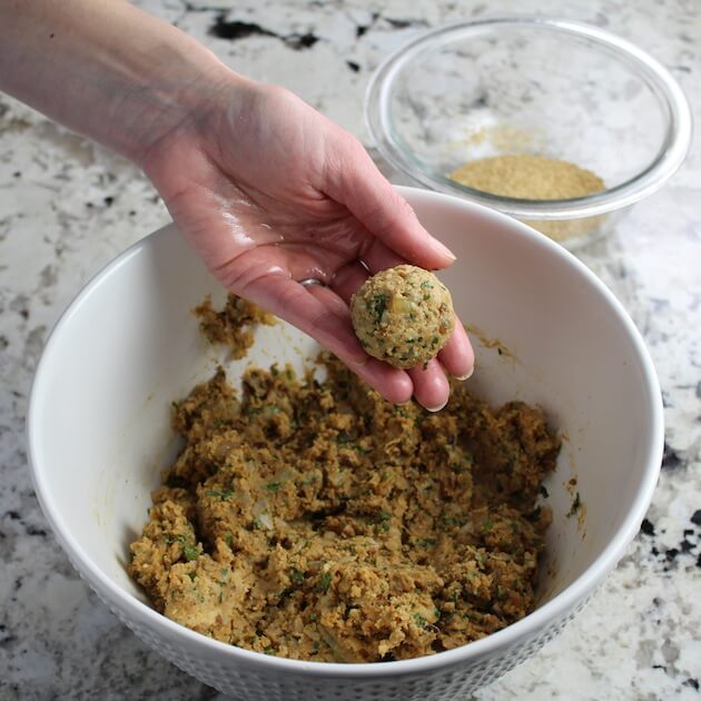 Rolled meatballs over a mixing bowl