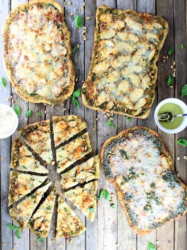 Four Chicken Pesto Pizzas on a farm table