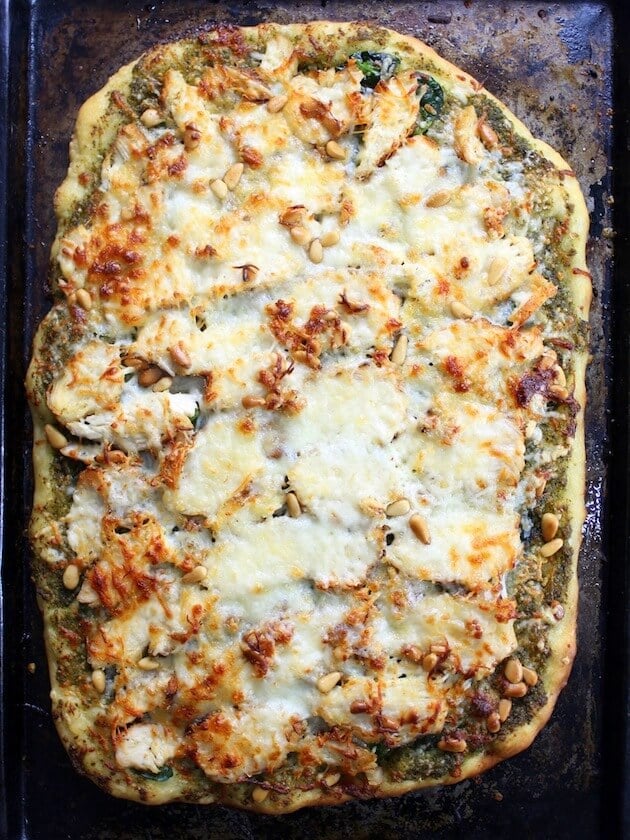 Overhead baked Chicken Pesto Pizza on cookie sheet 