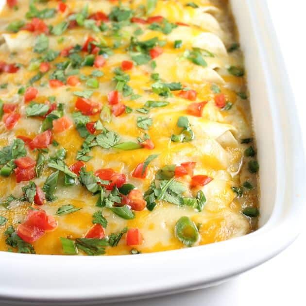 Partial Casserole dish of Enchiladas smothered in cheese 