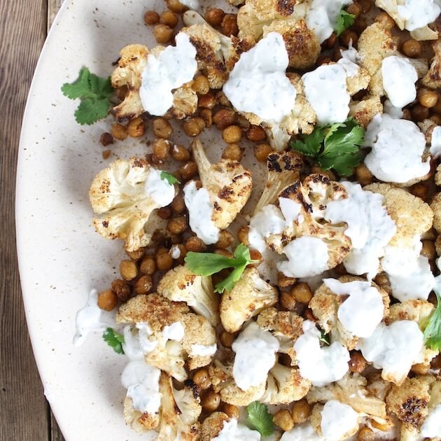 Partial platter of Roasted Cauliflower And Chickpeas With Yogurt Sauce