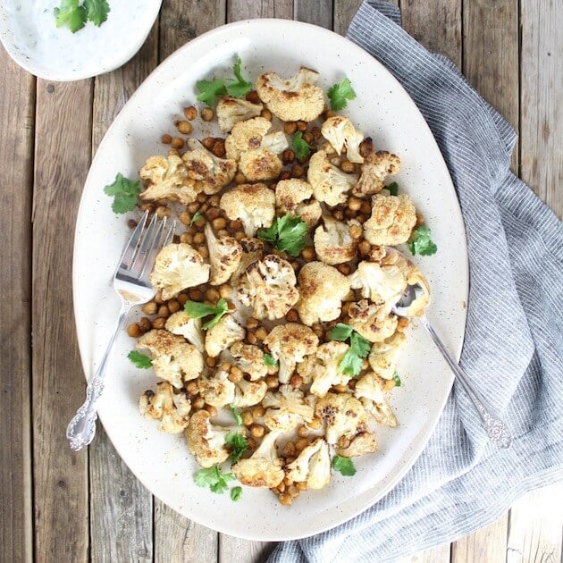 Platter of Roasted Cauliflower And Chickpeas With Yogurt Sauce