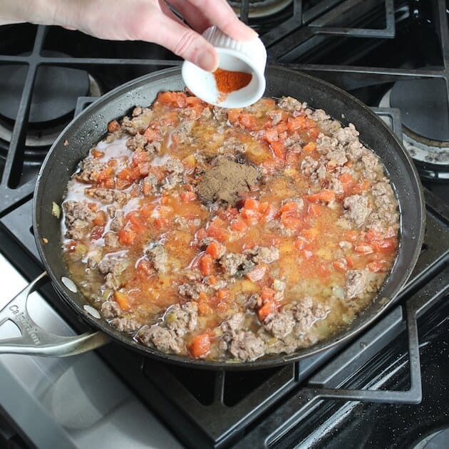 Adding cayenne to pan of ingredients sauteeing