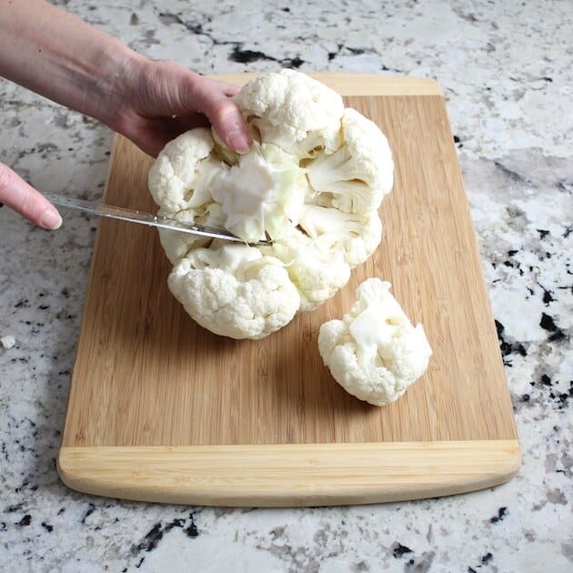 Trim stalk from head of cauliflower