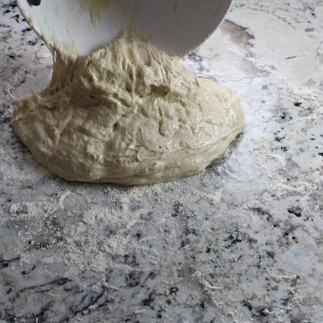 Rolling pizza dough on floured counter