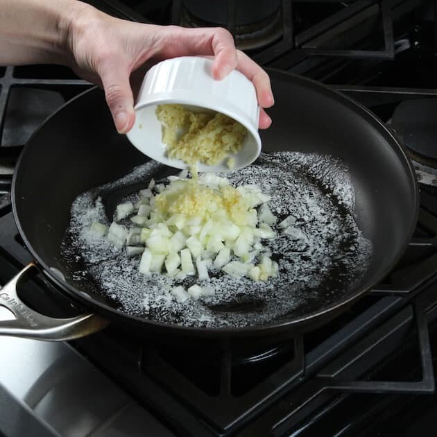 Adding garlic to onions in saute pan