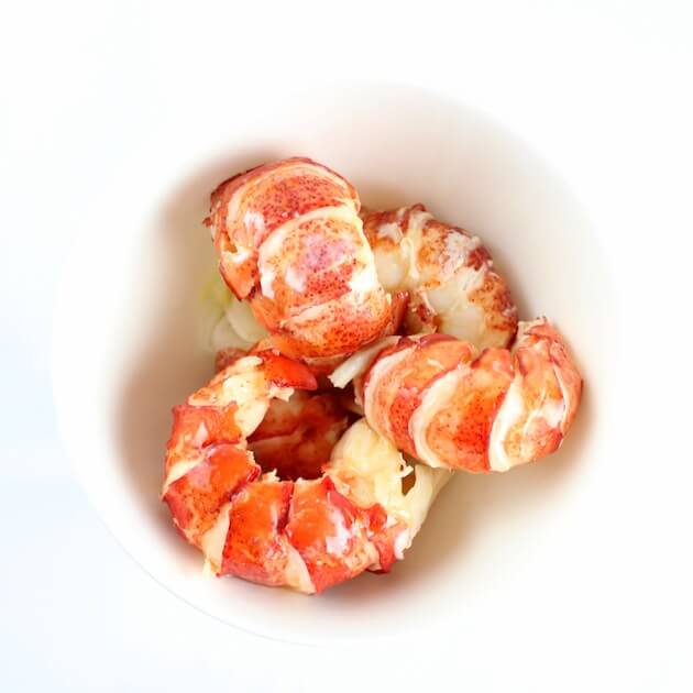 Cooked lobster tails in a white bowl