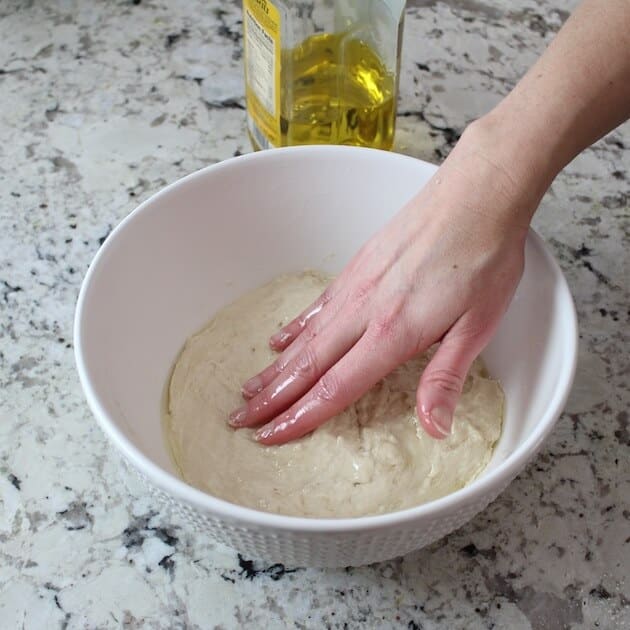 Adding olive oil on pizza  dough