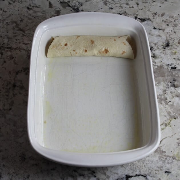 Adding stuffed tortillas to casserole dish