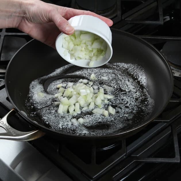 Adding onions to saute pan on stovetop
