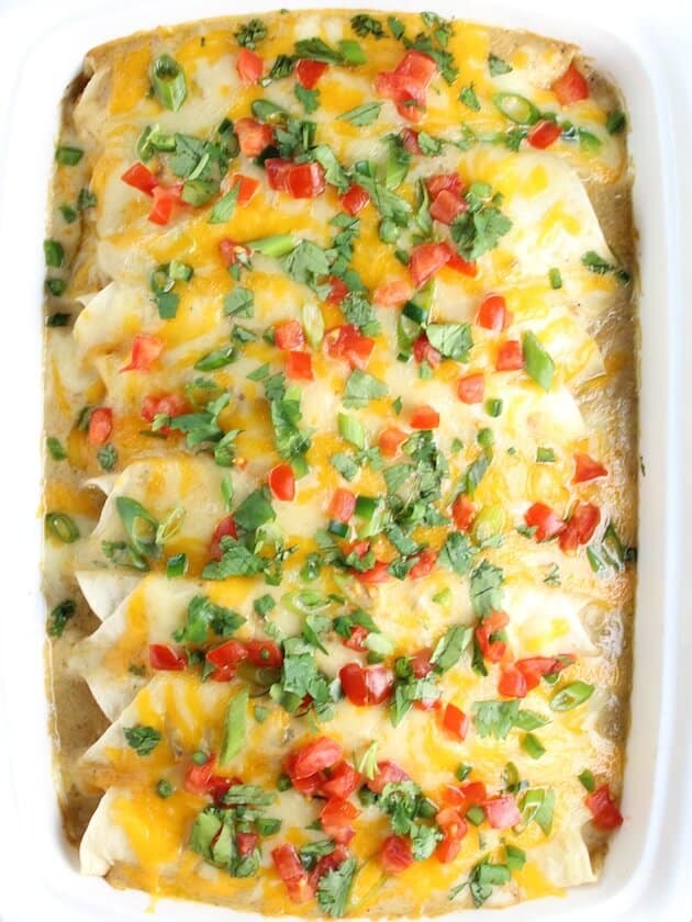 Overhead Eight beautiful Cheesy Chicken Enchiladas in casserole dish