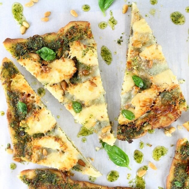 Chicken Pesto Pizza slices on parchment paper