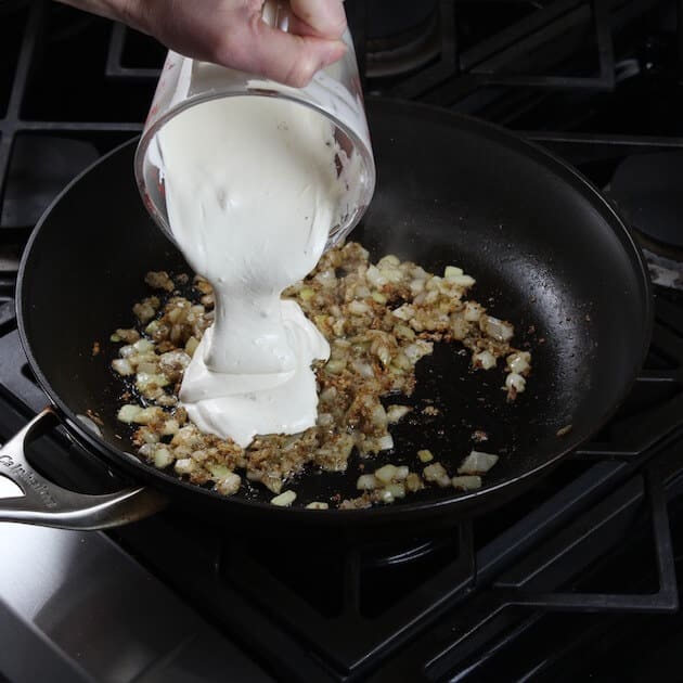 Adding sour cream to saute pan with onions
