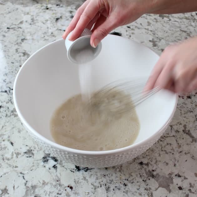 Adding sugar to yeast in mixing bowl