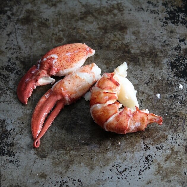 Lobster claw and tail meat on baking sheet