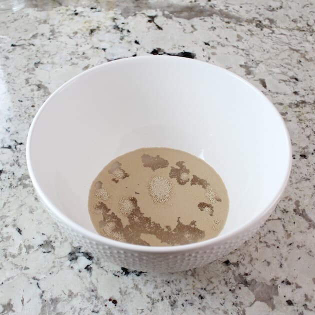 yeast bubbling in water inside a mixing bowl