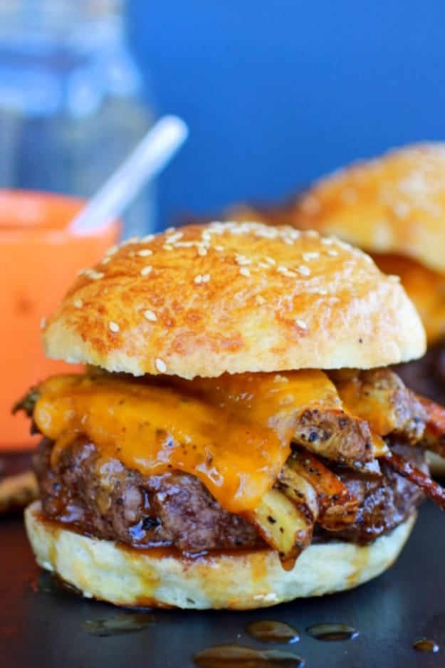 Cheeseburger with french fries under the melted cheese 