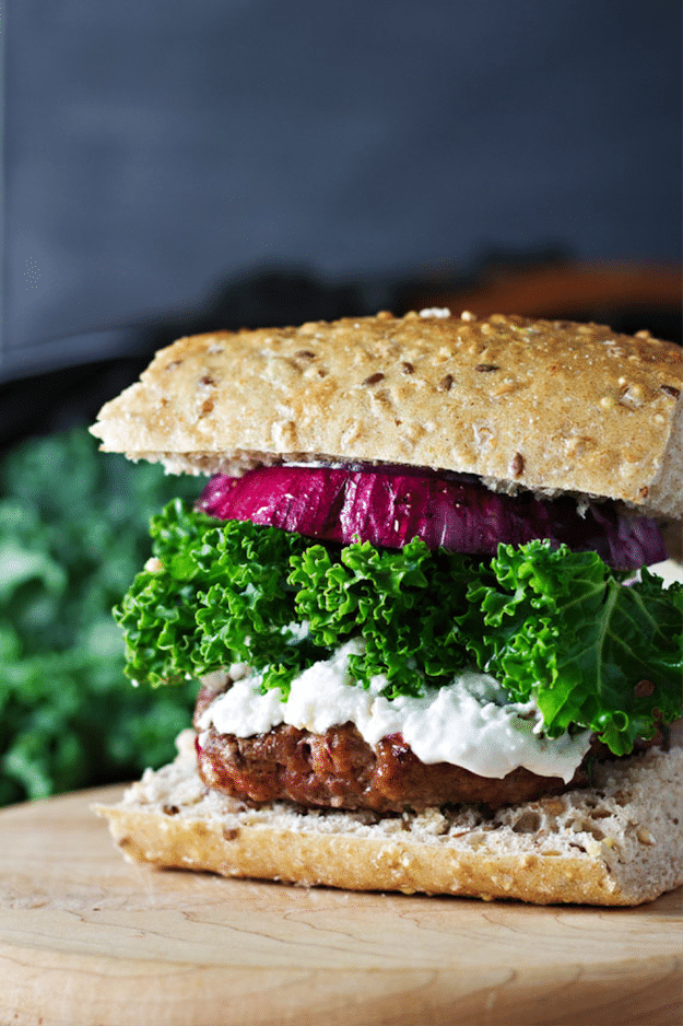 Burger on hearty bread with kale and red onion