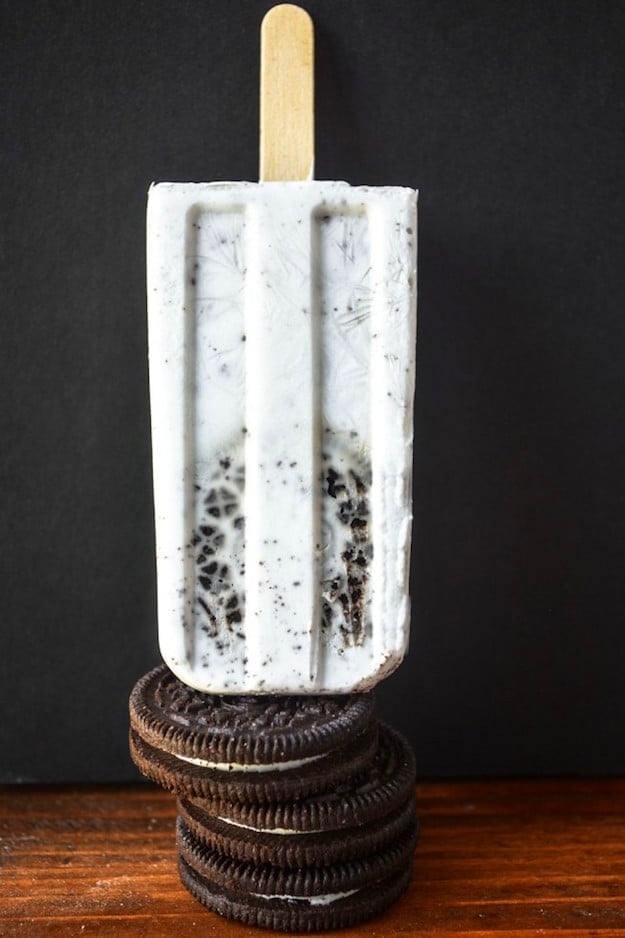 Oreo cookie popsicle balanced on top of stacked oreos