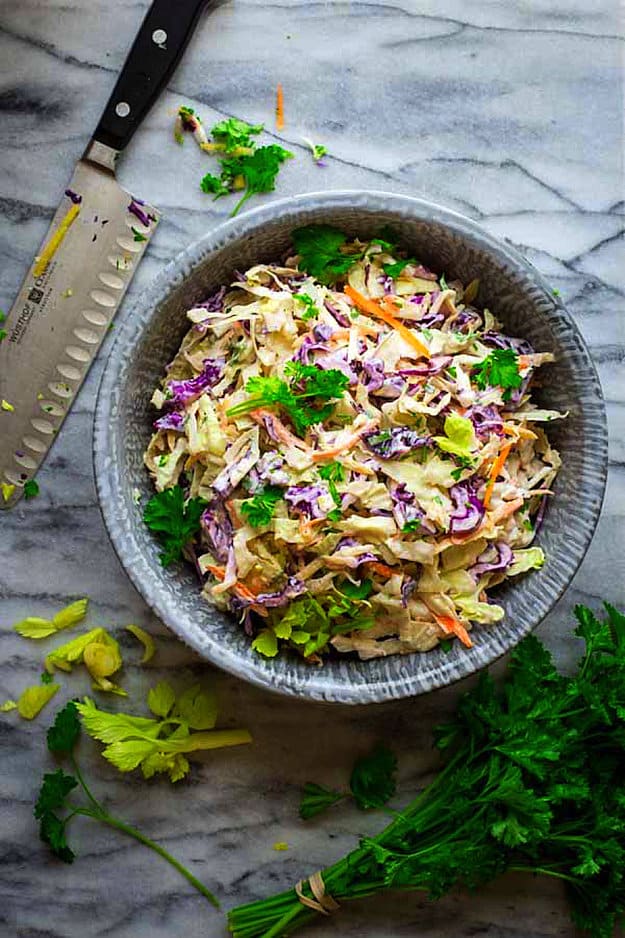 Coleslaw in a bowl on marble counter