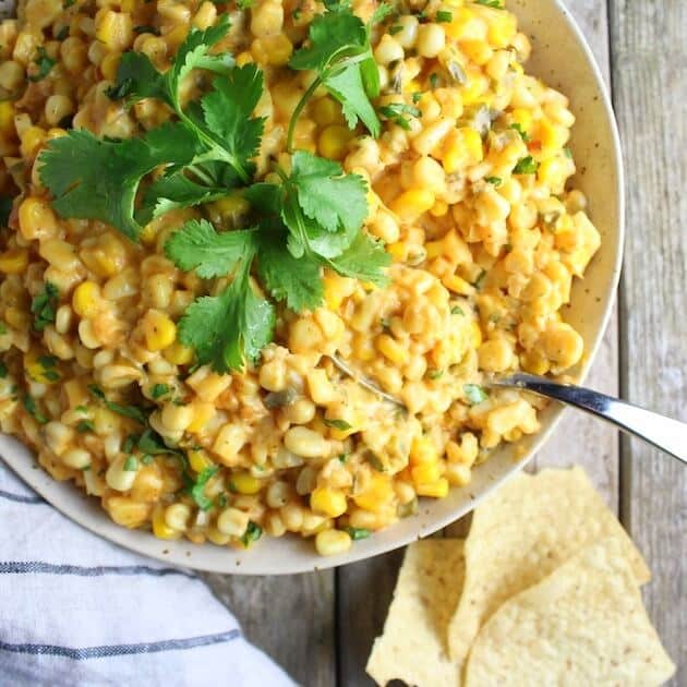 Creamy Cheesy Corn Dip in serving bowl with spoon