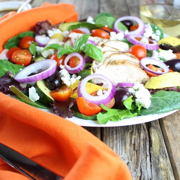 Eye level Grilled Chicken Salad with red onion, kalamata olives, and feta