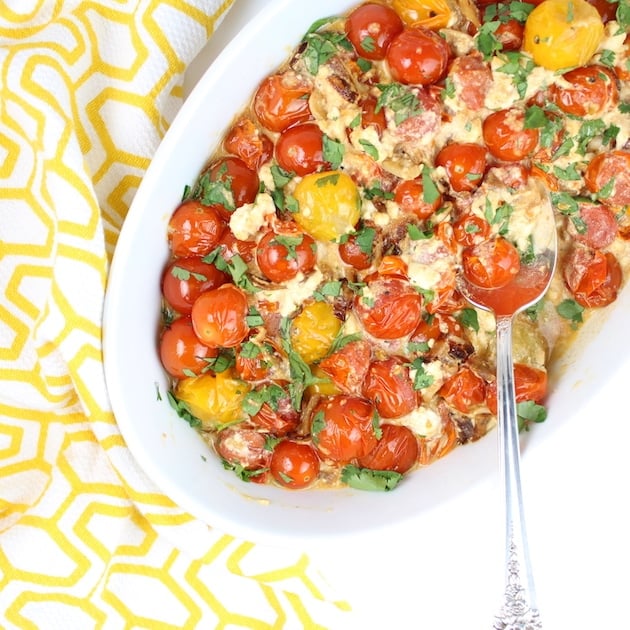 Sweet Cherry Tomatoes with French Feta in a serving dish on yellow pattern cloth