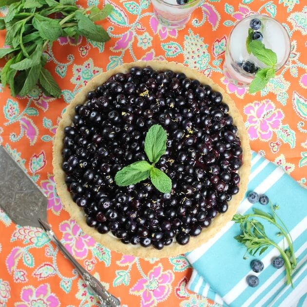 Summer Blueberry Pie with shortbread crust on festive tablecloth