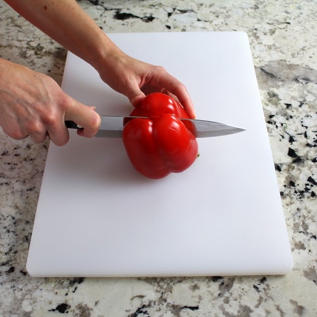 cutting red pepper on white cutting board