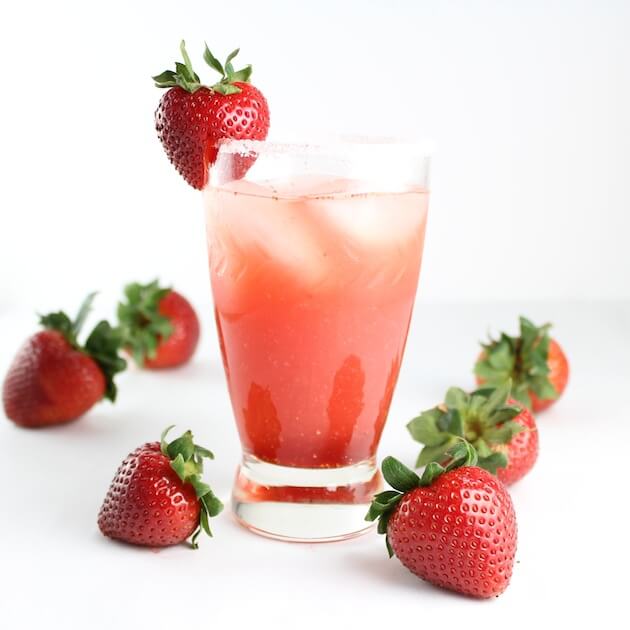 Fresh Strawberry Margarita in a glass surrounded by strawberries
