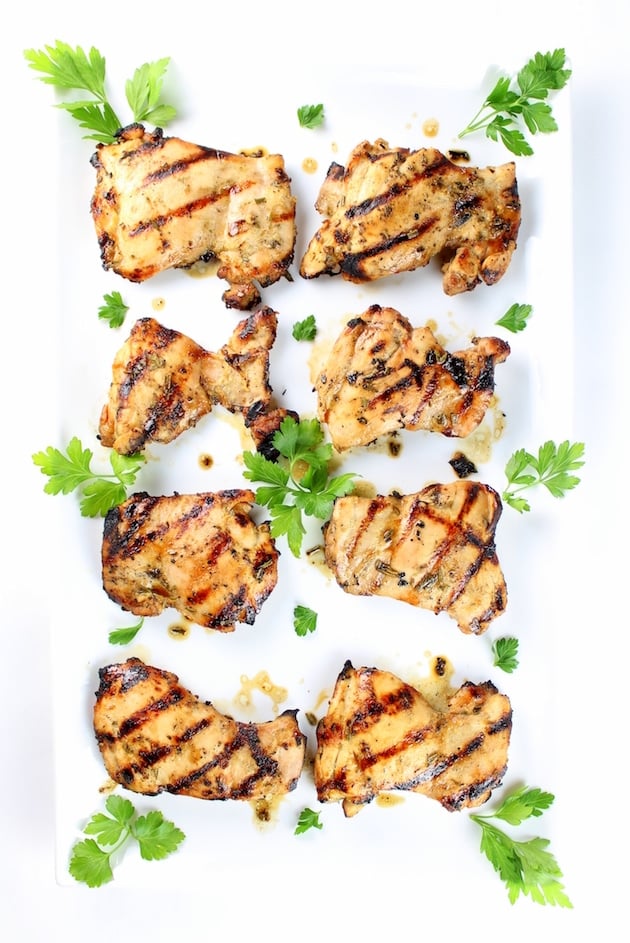Eight Grilled Chicken Thighs on a white platter