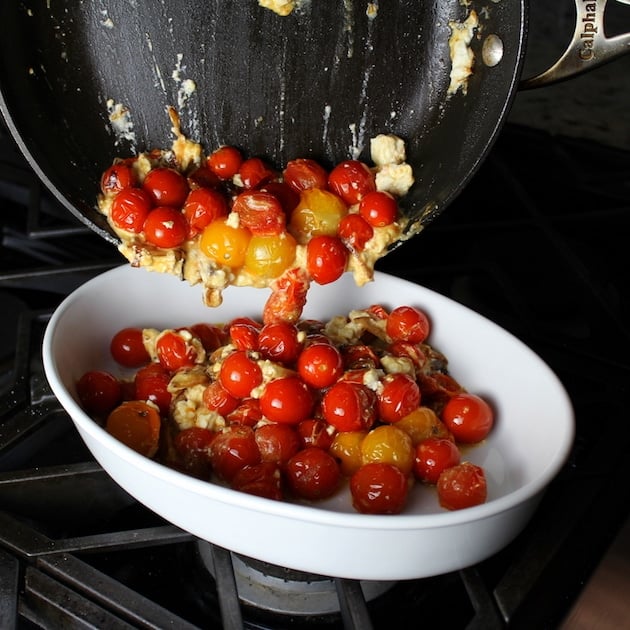 Transferring cooked Cherry Tomatoes to serving dish