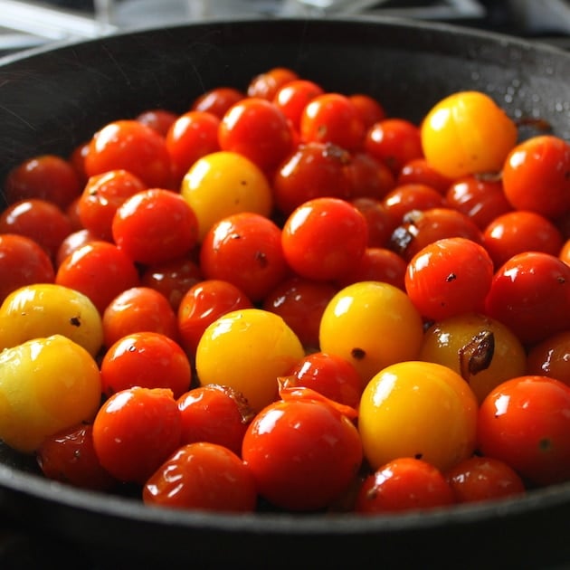 Golden and red cherry tomatoes in saute pan