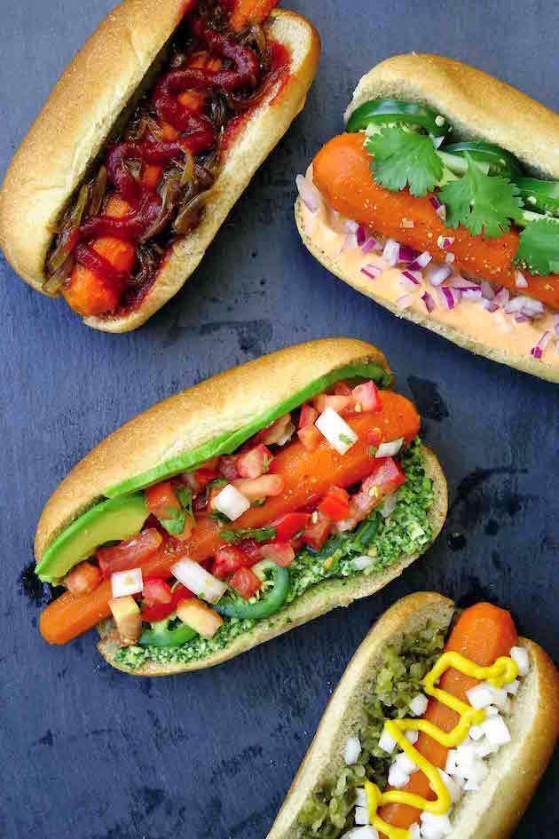 Four hot dog buns with carrots and vegetables