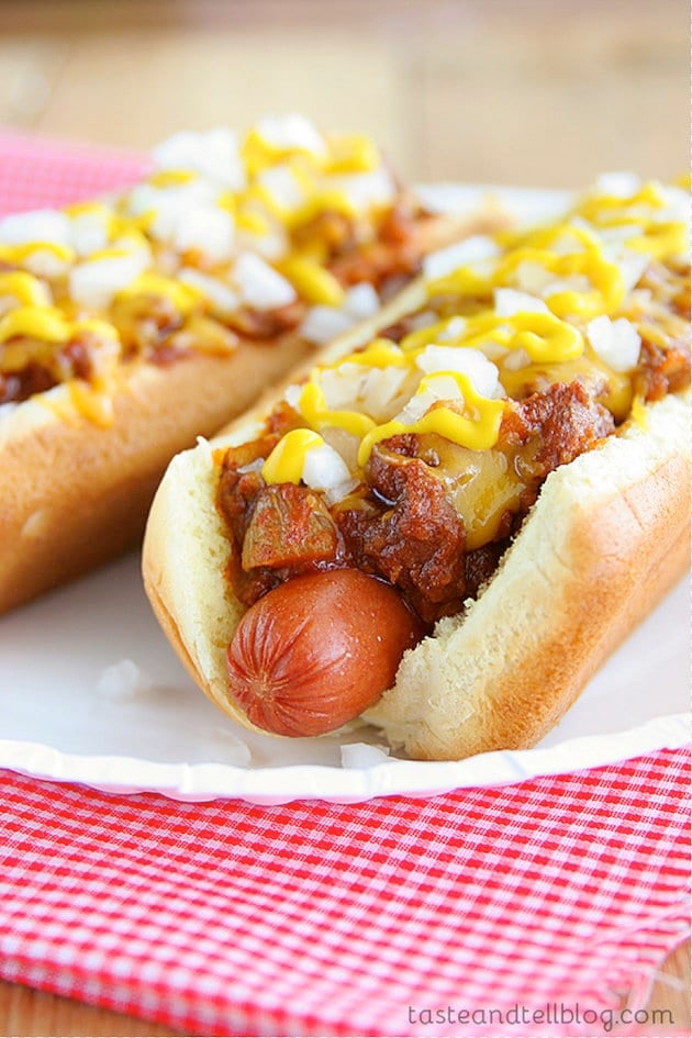 Two chili dogs on a paper plate